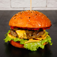 Tasty Burger on a plate in cafe.