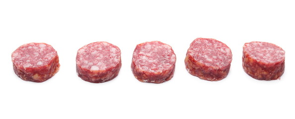 Fermented, dry chopped sausage slices isolated on white background