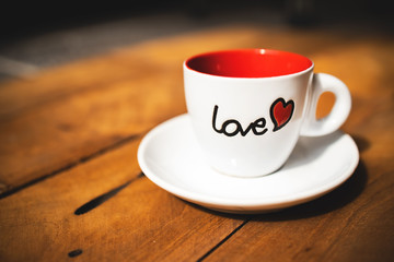 Espresso mug on wooden table . Valentine concept.