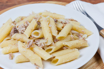 Penne pasta with stewed ground meat in navy-style closeup