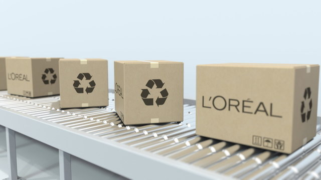 L'OREAL logo on moving boxes on roller conveyor. Editorial 3D rendering