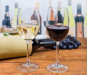 Two glasses of red and white wine on rustic table