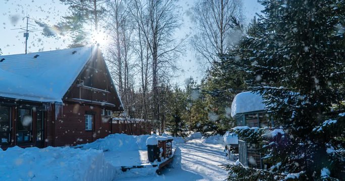 Cinemagraph, Winter sunny landscape in the forest with a house, slow beautiful snowfall, video loop