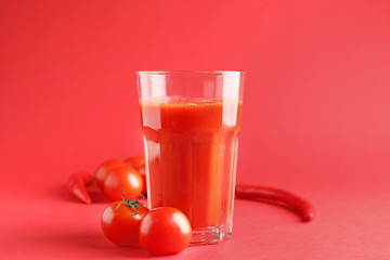 Glass of fresh vegetable juice on color background