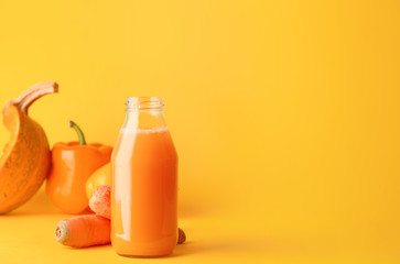 Bottle of fresh vegetable juice on color background
