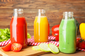 Bottles of fresh vegetable juices on table