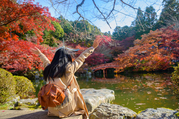Woman traveller tourist enjoy and happiness to see the scenery view of autumn village in Japan countryside, Autumn season change blooming on popular and famous place for tourist visit Japan
