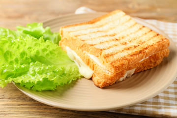 Tasty sandwiches with cheese on plate