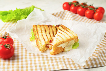 Tasty sandwiches with cheese on table
