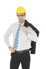 Standing smart engineer in white shirt arm akimbo wearing yellow helmet and safety glasses isolated on white background