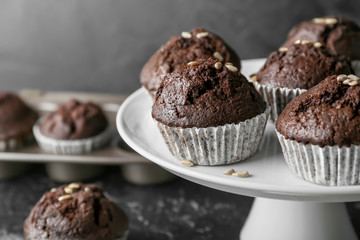 Dessert stand with tasty chocolate muffins, closeup