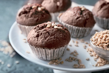 Dessert stand with tasty chocolate muffins, closeup