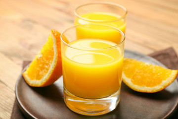 Naklejka na ściany i meble Glasses of fresh orange juice on table