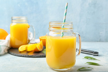 Mason jar of fresh orange juice on table
