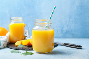 Mason jar of fresh orange juice on table