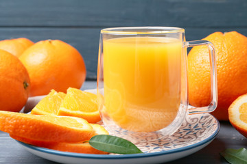 Glass cup of fresh orange juice on table