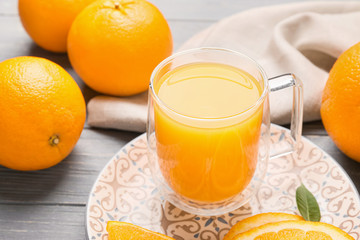 Glass cup of fresh orange juice on table
