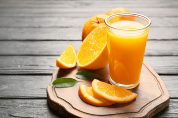 Fototapeta na wymiar Glass of fresh orange juice on table