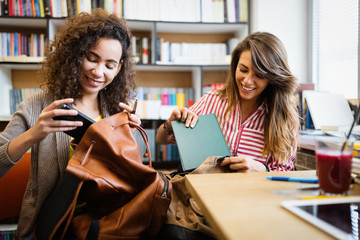 Group of college students studying in the school library.