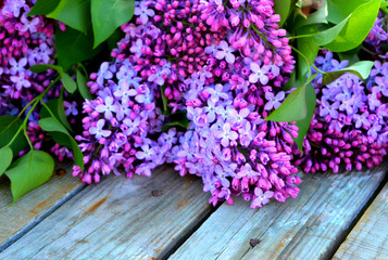 Bouquet of lilac on a wooden background. Beautiful spring floral composition