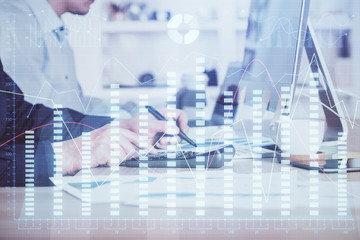 Forex graph with businessman working on computer in office on background. Concept of hardworking. Closeup. Multi exposure.