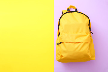 School backpack on color background