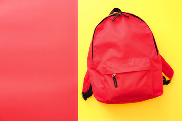 School backpack on color background