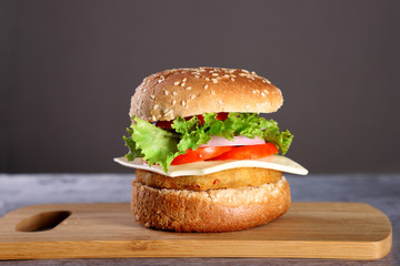 Fast Food - Burger on a wooden board