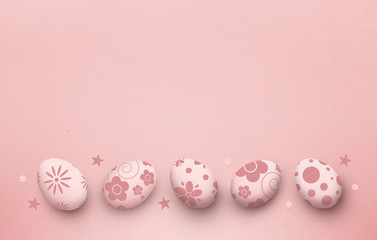 easter eggs on pink paper background, top view