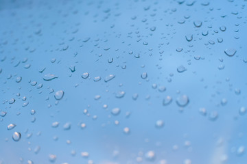 Drops on the glass against a beautiful blue-purple sky with clouds
