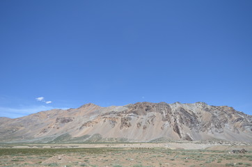 the view of Himalaya mountains on a sunny day under the blue sky in the morning or the evening in Tibet India China the road on high altitudes