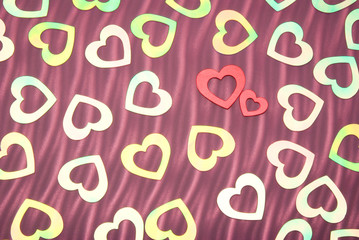 Valentine's Day background of shiny iridescent hearts on a textured background