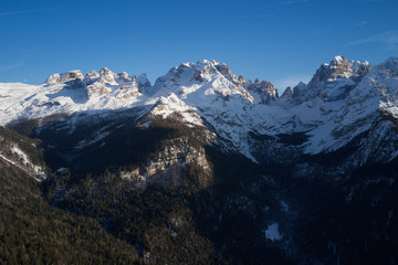 Panoramic aerial view of  Brenta Dolomites, Cima Tosa, Italy, snow on the slopes of the Alps  Madonna di Campiglio, Pinzolo, Italy. The most popular ski resorts in Italy. Aerial photography with drone