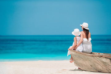 Beautiful mother and daughter at the beach enjoying summer vacation. © travnikovstudio
