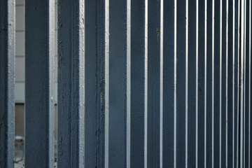 perspective: metal painted fence on the street