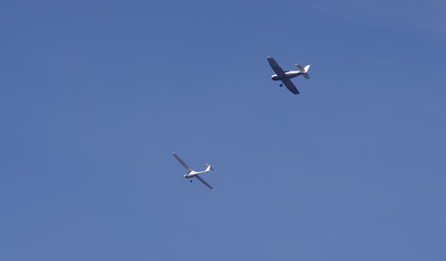 two airplanes flying in the blue sky