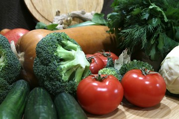 Green broccoli cabbage, cucumbers, tomatoes, cabbage and greens fresh side view.