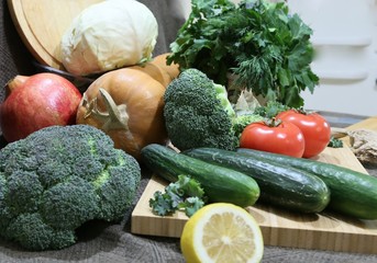 Together washed vegetables clean and ready for cooking: broccoli, parsley greens, tomatoes, lemon, cabbage, cucumber