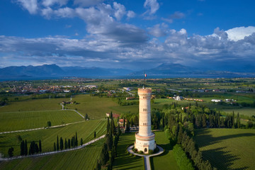 Tower of San Martino della Battaglia, Italy. Tower surrounded by vineyards, blue sky