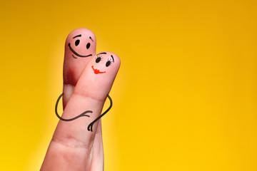 Valentine's day concept. 2 fingers with painted smiling faces symbolize love and friendship.