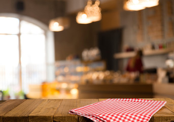 Empty brown wooden table and blur background of abstract of resturant lights people enjoy eating ,can be used for montage or display your products