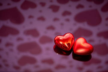 Two red hearts against holiday defocused  background. Valentines day concept.