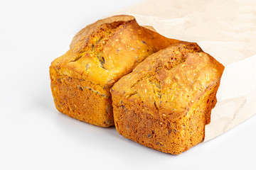 Two loaves of whole-grain bread on white background. Freshly baked homemade square bread. Organic and vegetarian food concept. Copy space for text,