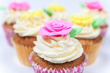 Cup Cakes With Colorful Flowers and Icing or Frosting