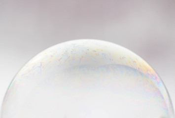 Macrophotography of a soap bubble. Multicolored streaks on the surface of the soap bubble