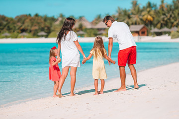 Happy beautiful family of four on the beach