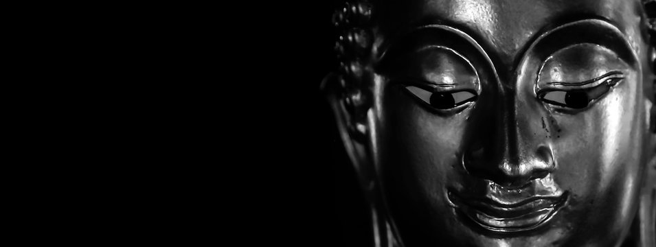 Selective focus  close-up shots  of the Buddha's face. space for the text layout Is a beautiful religious background