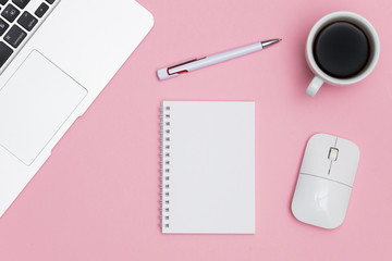 Minimal workplace with laptop, coffee cup and blank notepad on colored background. Top view. Flat lay