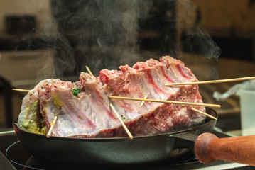 frying delicious juicy pork on the black frying pan