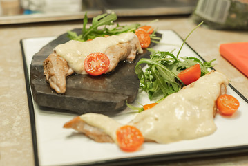 serving a juicy pork with fresh vegetables and original sauce